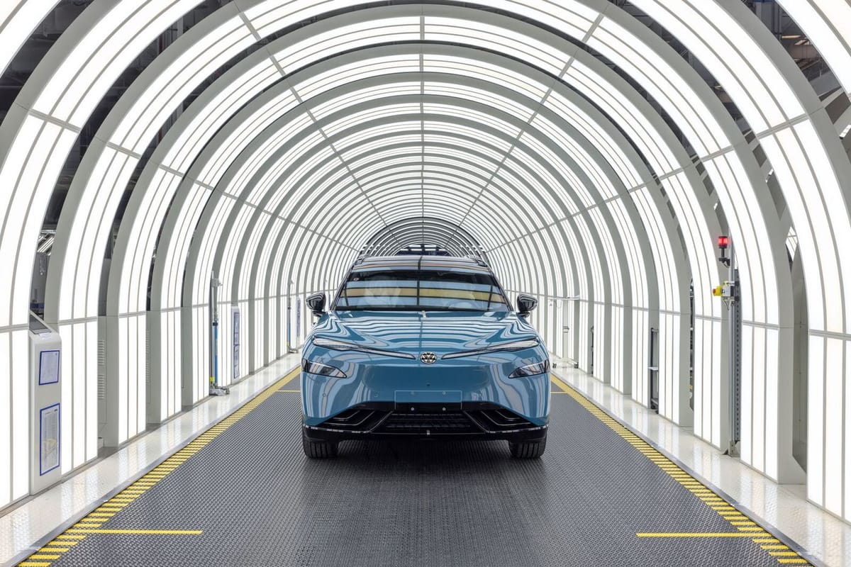 Blaues Elektro-SUV VW ID. UNYX 08 in einem hell beleuchteten Lichttunnel im Werk von Volkswagen Anhui in Hefei